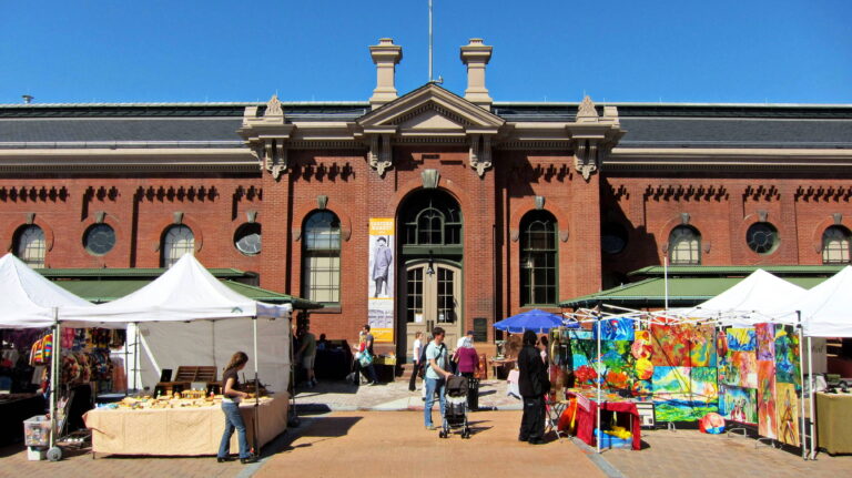 The brick facade of Eastern Market, with vendors set up on the sidewalk outside