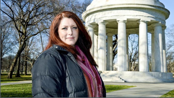 An image of a woman in front of a Washington DC memorial